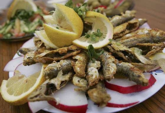 NETANYA, ISRAEL - FEBRUARY 22: A meal of fried sardines is served in a restaurant in the local produce market February 22, 2006 in Netanya in central Israel. Fish, which the American Heart Association says have important health benefits, is a regular feature on regional menus. The Mediterranean diet, a term used to broadly describe the eating habits of the people of the area, is widely believed to be responsible for the low rates of chronic heart disease in the populations of the 16 countries bordering the Mediterranean Sea. (Photo by David Silverman/Getty Images)