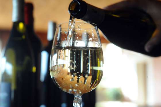 A picture taken on October 10, 2012 shows French wine owner and producer Caroline Cassot pouring white wine in a glass in Prayssac, in the French southwestern wine producing region of Cahors. Caroline Cassot will produce a Cahors white wine, although Cahors wines are usually red wines from grapes grown in or around the town of Cahors. AFP PHOTO / REMY GABALDA        (Photo credit should read REMY GABALDA/AFP/GettyImages)