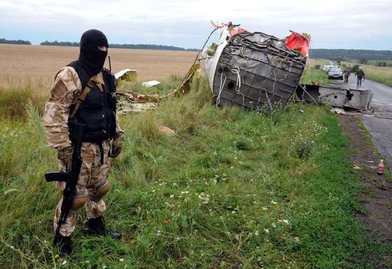 An armed pro-Russia militant stands guard at the site of the crash of a Malaysian airliner carrying 298 people from Amsterdam to Kuala Lumpur in Grabove, in rebel-held east Ukraine, on July 18, 2014. Pro-Russian separatists in the region and officials in Kiev blamed each other for the crash, after the plane was apparently hit by a surface-to-air missile. Members of the UN Security Council demanded a full, independent investigation into the apparent shooting down of a Malaysia Airlines jet over Ukraine.  AFP PHOTO / DOMINIQUE FAGET        (Photo credit should read DOMINIQUE FAGET/AFP/Getty Images)