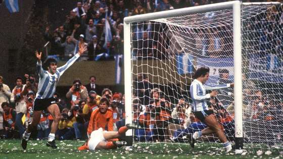 BUENOS AIRES, ARGENTINA - JUNE 25: Argentinian midfielder Mario Kempes (L) who just scored his second goal celebrates in front of forward Daniel Bertoni and Dutch defenders Wim Suurbier (on ground) and Ruud Krol (facing camera) 25 June 1978 in Buenos Aires during the extra time period of the World Cup soccer final between Argentina and the Netherlands. Kempes gave Argentina a 2-1 lead and Bertoni later scored a third goal to give Argentina its first-ever World title with a 3-1 victory. AFP PHOTO (Photo credit should read STAFF/AFP/Getty Images)