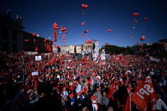 Protestors stand in San Giovanni square during a demonstration organised by Italian General Confederation of Labour (CGIL) union on October 25, 2014 in central Rome as part of a nationwide protest called by the union to protest Prime Minister Matteo Renzi's plans to overhaul the labour market.  AFP PHOTO/ Filippo MONTEFORTE        (Photo credit should read FILIPPO MONTEFORTE/AFP/Getty Images)