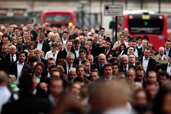 LONDON, ENGLAND - OCTOBER 04: Commuters walk across London Bridge during morning rush hour on October 4, 2010 in London, England. London Underground workers are staging a 24 hour walk out over concerns at plans to cut jobs, causing large disruption to the capitals transport network. (Photo by Matthew Lloyd/Getty Images)