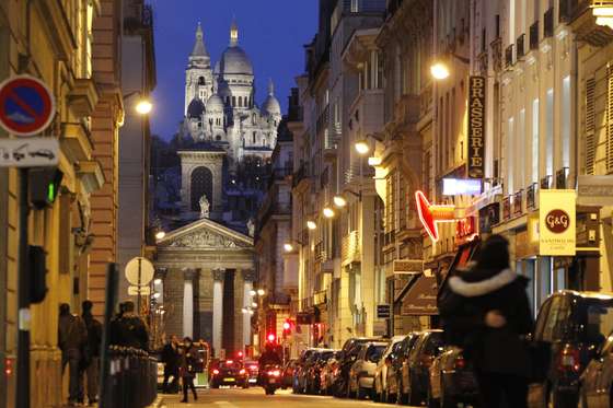 Photo taken by night on February 14, 2014 shows a view of the Notre-Dame-de-Lorette church (bottom) and the Basilica of the Sacre Coeur in Paris. AFP PHOTO / LUDOVIC MARIN (Photo credit should read LUDOVIC MARIN/AFP/Getty Images)