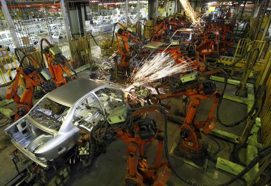 TO GO WITH AFP STORY BY ARESUE EQBALI (FILES) -- File picture dated September 30, 2008 shows robots working on an Iranian-made Samand car at the Iran Khodro auto plant, west of Tehran. Neither West, nor East" was the slogan adopted after the Islamic revolution 30 years ago, but the call for self-reliance has yielded mixed economic results and oil-rich Iran still battles for prosperity. The Islamic republic is OPEC's second largest oil producer and it sought economic growth by investing heavily in its scientific programmes, but it also burdened itself with imports worth billions of dollars.  AFP PHOTO/BEHROUZ MEHRI (Photo credit should read BEHROUZ MEHRI/AFP/Getty Images)