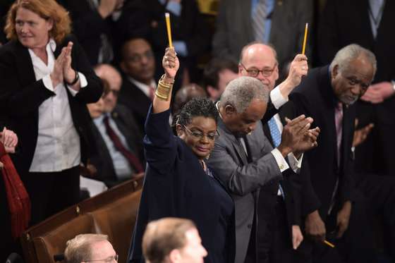 US lawmakers pay tribute to the victims of the Paris attacks by holding up pencils during the State of the Union address by US President Barack Obama, before a joint session of Congress on January 20, 2015 at the US Capitol in Washington, DC.   AFP PHOTO/JIM WATSON        (Photo credit should read JIM WATSON/AFP/Getty Images)