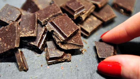 A woman takes a piece of chocolate displayed at a stand as part of the "Salon du Chocolat" (chocolate fair) on March 9, 2012, in Lille. AFP PHOTO / PHILIPPE HUGUEN (Photo credit should read PHILIPPE HUGUEN/AFP/Getty Images)