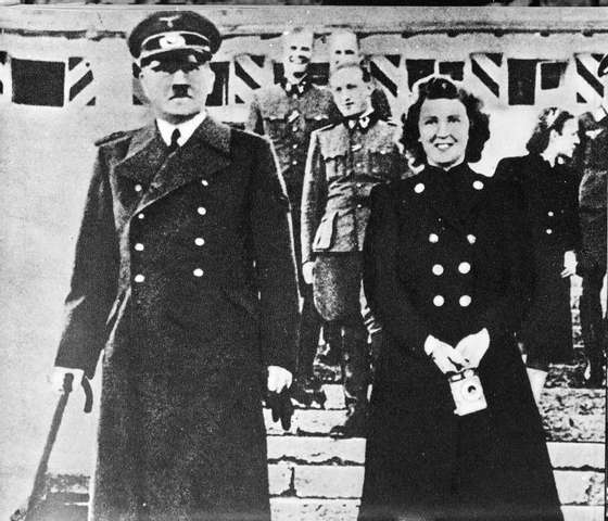 German dictator Adolf Hitler (1889 - 1945) with his mistress Eva Braun (1912 -1945), whom he married on April 29, 1945, the day before they committed suicide, early to mid 1940s. Hitler holds a cane, and Braun holds a camera. (Photo by Hulton Archive/Getty Images)