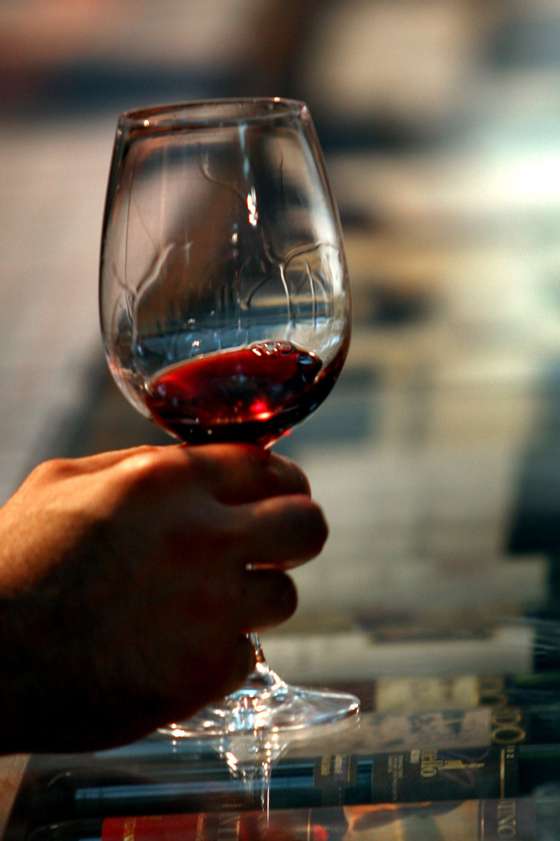 TEL AVIV, ISRAEL - NOVEMBER 13:  A visitor swirls a red wine in his galss at the Sommelier 2007 wine festival, the premier gathering for Israeli food and wine prefessionals November 13, 2007 in Tel Aviv. Wine was first produced in the Land of Israel in biblical times, and 125 years have past since Baron Edmond de Rothschild established Israel's modern wine industry in 1882. Today, consumption has risen to more than 7 litres per person per annum with both boutique wineries such as Margalit and large-scale producers such as Carmel Mizrahi and Golan Heights using innovative techniques, chemistry and Israel's diverse terroir to produce award-winning wines.  (Photo by David Silverman/Getty Images)