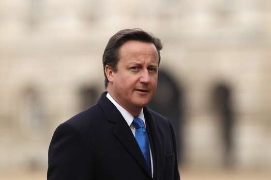 LONDON, ENGLAND - NOVEMBER 22:  British Prime Minister David Cameron walks across Horse Guards Parade after joining HM Queen Elizabeth II and Prince Philip, Duke of Edinburgh for the official welcoming of the President of Turkey Abdullah Gul on November 22, 2011 in London, England. The President of Turkey is on a five day State visit to the UK.  (Photo by Dan Kitwood/Getty Images)