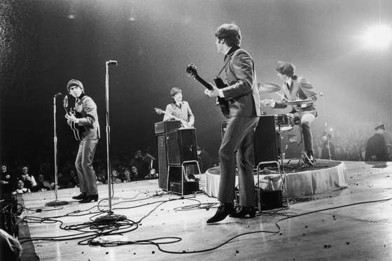 13th February 1964:  The Beatles in performance at the Washington Coliseum. Left to right : George Harrison (1943 - 2001), Paul McCartney, John Lennon (1940 - 1980) and Ringo Starr.  (Photo by Central Press/Getty Images)
