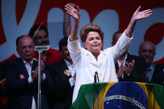 BRASILIA, BRAZIL - OCTOBER 26:  Brazilian President and Workers' Party (PT) candidate Dilma Rousseff (C) celebrates with Brazil's former president Luiz Inacio Lula Da Silva (R) after being re-elected on October 26, 2014 in Brasilia, Brazil.  Rousseff defated Presidential candidate of the Brazilian Social Democratic Party (PSDB) Aecio Neves in a run-off election.  (Photo by Mario Tama/Getty Images)