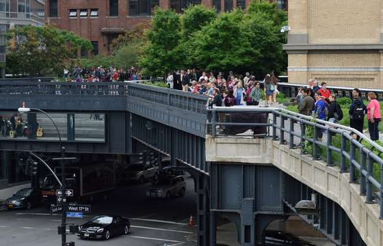 Visitors look down on the city streets and up to the Manhattan skyline from the High Line May 18, 2015 in New York. AFP PHOTO/DON EMMERT        (Photo credit should read DON EMMERT/AFP/Getty Images)