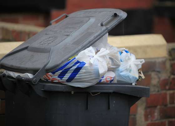LEEDS, ENGLAND - OCTOBER 01:  Overflowing refuse bins litter the streets in the Beeston area of Leeds on October 1, 2009 in Leeds, England. A strike by bin men in Leeds is now entering its fourth week with many streets overflowing with rubbish bags creating a public health hazard. The strike centres on a proposal to cut the workers wages by GBP 5000 due to recent equality legislation.  (Photo by Christopher Furlong/Getty Images)