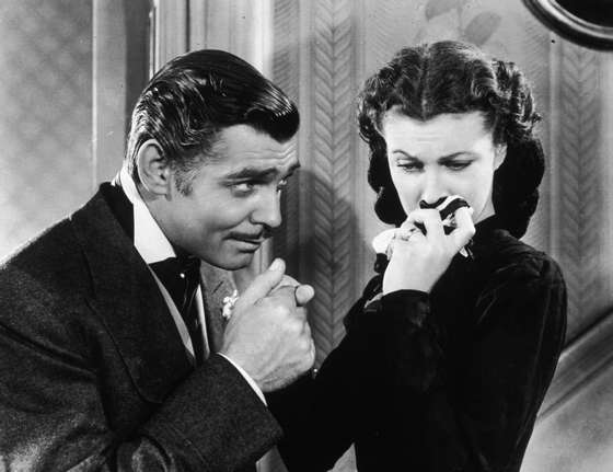 American actor Clark Gable (1901 - 1960) in his role as Rhett Butler kissing the hand of a tearful Scarlett O'Hara, played by Vivien Leigh in 'Gone With The Wind'. (Photo by Hulton Archive/Getty Images)