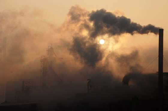 This picture taken on January 17, 2013 shows a cement factory releasing heavy smoke in Binzhou, in eastern China's Shandong province. China's economy grew at its slowest pace in 13 years in 2012, the government said on January 18, but an uptick in the final quarter pointed to better news ahead for a prime driver of the tepid global recovery.  CHINA OUT     AFP PHOTO        (Photo credit should read STR/AFP/Getty Images)