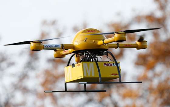 BONN, GERMANY - DECEMBER 09:  A quadcopter drone arrives with a small delivery at Deutsche Post headquarters on December 9, 2013 in Bonn, Germany. Deutsche Post is testing deliveries of medicine from a pharmacy in Bonn in an examination into the viability of using drones for deliveries of small packages over short distances. U.S. online retailer Amazon has also started its intention to explore the possibilities of using drones for deliveries.  (Photo by Andreas Rentz/Getty Images)