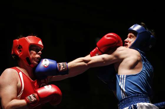 TO GO WITH STORY BY JACQUES KLOPP Participants land punches during the "Brawl at the Hall" white-collar boxing event at York Hall in Bethnal Green, London on November 13, 2014. The event held at one of Britain's best known boxing venues saw white-collar workers fight each other for 3 two-minute rounds. A growing number of City workers are ditching the tie and lacing up the gloves for "white-collar events". AFP PHOTO / ADRIAN DENNIS (Photo credit should read ADRIAN DENNIS/AFP/Getty Images)