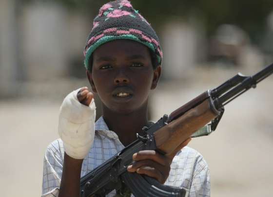 A young fighter from the Al-Shabab militia shows the wound in his hand which he suffered while battling Somali government forces in a frontline section in Sinaya Neighborhood in Mogadishu, on July 13, 2009. According to the Islamist militants, Al-Shabab fighters and Hizbul Islam fighters regained some of their position overnight which they had lost to the government soldiers over the weekend. Paramedics, police and government forces said the fighting Sunday spread across several districts of the city and claimed many lives. "The ambulances collected 75 injured civilians and 14 dead bodies of civilians," Ali Muse, the head of the city's ambulance service, told AFP. "Some of them were killed by mortar and artillery shells and others by crossfire." AFP PHOTO/Mohamed DAHIR (Photo credit should read MOHAMED DAHIR/AFP/GettyImages)