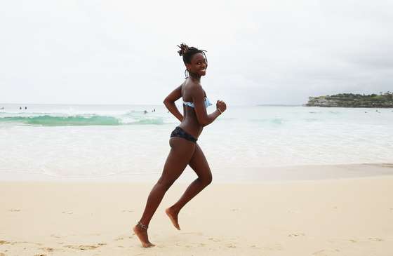 SYDNEY, AUSTRALIA - DECEMBER 25: Aasiya, from Paris, France, jogs along the waters edge at Bondi Beach on December 25, 2013 in Sydney, Australia. Bondi Beach has long been a popular place for tourists and Australians alike to celebrate on a hot Christmas Day. (Photo by Don Arnold/Getty Images)