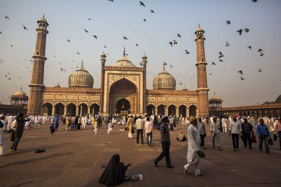 DELHI, INDIA - OCTOBER 27: A woman begs for alms as Indian Muslims mingle after Eid al-Adha prayers at Jama Masjid on October 27, 2012 in New Delhi, India. Eid al-Adha, also known as the Feast of Sacrifice, commemorates Abraham's willingness to sacrifice his son as an act of obedience to God, who in accordance with tradition then provided a lamb in the boy's place. (Photo by Daniel Berehulak/Getty Images)