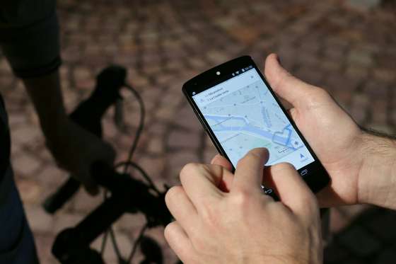 A man uses a GPS app on a smartphone during a Google promotion event at the City of Fashion and Design (Cite de la mode et du design) in Paris on November 4, 2014. AFP PHOTO / THOMAS SAMSON (Photo credit should read THOMAS SAMSON/AFP/Getty Images)