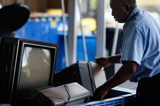 POMPANO BEACH, FL - JUNE 05: Tommy Bass places an analog television set into the discard bin after receiving it at the Broward County Waste & Recycling Services Solid Waste center on June 5, 2009 in Pompano Beach, Florida. As America switches to a digital signal on June 12th many are throwing out their old television sets. The switch to the digital television signal makes old analog televisions obsolete unless a converter box has been purchased. For the last 70 plus years people have watched television on analog. (Photo by Joe Raedle/Getty Images)