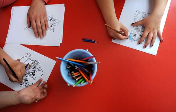 TO GO WITH AFP STORY Bulgaria-social-adoption-children,FEATURE, by Vessela Sergueva (FILES) This picture taken on May 14, 2010, shows children colouring a pattern in a Daycare centre for children in the town of Teteven, some 100 km north-east from capital Sofia. Some 6,730 children are abandoned in institutions in Bulgaria due to the poverty of their families. AFP PHOTO / NIKOLAY DOYCHINOV (Photo credit should read NIKOLAY DOYCHINOV/AFP/Getty Images)