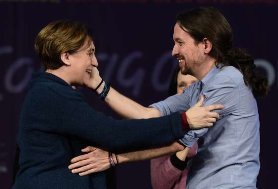 Leader of left wing party Podemos and candidate for the upcoming December 20 general election, Pablo Iglesias (R) hugs Barcelona's Mayor Ada Colau during a campaign meeting in Madrid on December 13, 2015. Public over corruption across the political spectrum, as well as companies, unions, banks, celebrities, and even royalty could cost Spain's traditional parties dearly in upcoming elections as sky-high unemployment and austerity has seen the emergence of two new parties -- the anti-austerity Podemos and centrist Ciudadanos -- both threatening to the two-party monopoly at the polls says sociologist Jose Pablo Ferrandiz of polling institute Metroscopia. AFP PHOTO / JAVIER SORIANO / AFP / JAVIER SORIANO (Photo credit should read JAVIER SORIANO/AFP/Getty Images)