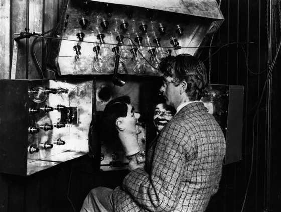 Scottish electrical engineer and television pioneer John Logie Baird (1888 - 1946) demonstrating his new invention the television with the aid of two ventriloquist's dummies. Baird was born in Helensburgh and studied at Glasgow University. Baird worked as an engineer at Clyde Valley Electric Power Company but had to retire due to ill health. He used his time to conduct experimental research into the transmission of images and gave a successful public display of his television system in London on 27th January 1926. In 1929 his mechanically scanned system was adopted by the BBC and he provided an improved system five years later. Baird also helped pioneer colour television and stereophonic sound. (Photo by Topical Press Agency/Getty Images)
