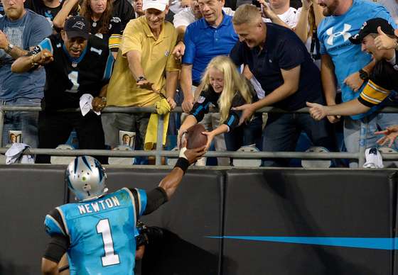 CHARLOTTE, NC - SEPTEMBER 21: Cam Newton #1 of the Carolina Panthers gives a fan a ball after a 3rd quarter touchdown against the Pittsburgh Steelers during their game at Bank of America Stadium on September 21, 2014 in Charlotte, North Carolina. (Photo by Grant Halverson/Getty Images)