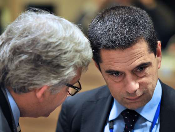 Portuguese Finance Minister Vitor Gaspar listens to his advisor prior to a meeting with European finance ministers on November 13, 2012 at the EU Headquarters in Brussels. Ministers focus on how to boost the slumping economy and the bloc's hotly contested budget after their eurozone peers reported progress on solving Greece's bailout problems. AFP PHOTO GEORGES GOBET (Photo credit should read GEORGES GOBET/AFP/Getty Images)