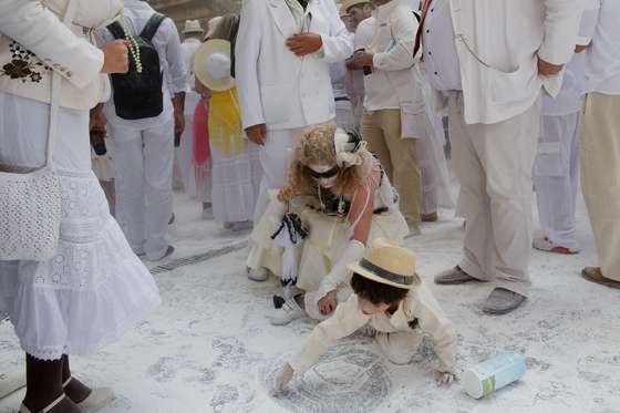 SANTA CRUZ DE LA PALMA, SPAIN - MARCH 03: A child plays with talcum powder on the ground during Los Indianos carnival on March 3, 2014 in Santa Cruz de La Palma, Spain. The origin of the 'Dia de los Indianos' (Day of the Indians) carnival is rooted in the emigration of people from the Canary Islands to Latin American countries, in particular Cuba, and their subsequent boastful return after discovering wealth across the ocean. (Photo by Pablo Blazquez Dominguez/Getty Images)