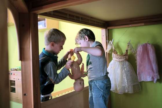 LAHNSTEIN, GERMANY - AUGUST 19: Boys play with a doll at 'Einsteinchen' child day care center on August 19, 2015 in Lahnstein, Germany. Rhineland-Palatinate Governor Malu Dreyer visits the "Einsteinchen" ("Little Einstein") child day care center. Workers at child day care centers (in German the centers are called kitas) are threatening to resume strikes in October, mostly over pay and working conditions. (Photo by Thomas Lohnes/Getty Images)