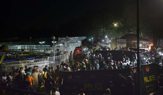 Pakistani rescuers and officials gather at a bomb blast site in Lahore on March 27, 2016. At least 25 people were killed and dozens injured when an explosion ripped through the parking lot of a crowded park where many minority Christians had gone to celebrate Easter Sunday in the Pakistani city Lahore, officials said. / AFP / ARIF ALI (Photo credit should read ARIF ALI/AFP/Getty Images)
