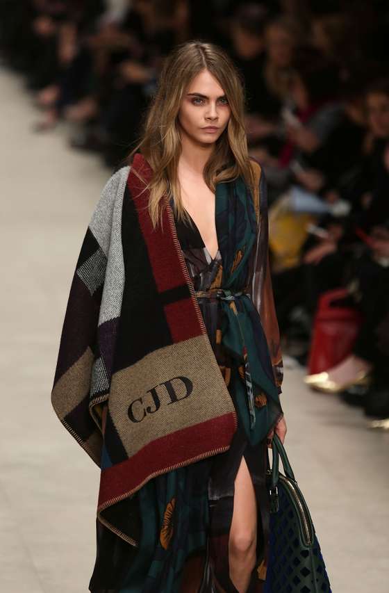LONDON, ENGLAND - FEBRUARY 17: Model Cara Delevingne walks the runway at the Burberry Prorsum show at London Fashion Week AW14 at Perks Fields, Kensington Gardens on February 17, 2014 in London, England. (Photo by Tim P. Whitby/Getty Images)