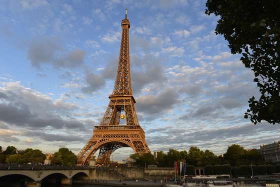 A giant tennis ball hangs under the Eiffel Tower on the sidelines of the Roland Garros 2015 French Tennis Open in Paris on May 25, 2015. AFP PHOTO / MIGUEL MEDINA (Photo credit should read MIGUEL MEDINA/AFP/Getty Images)
