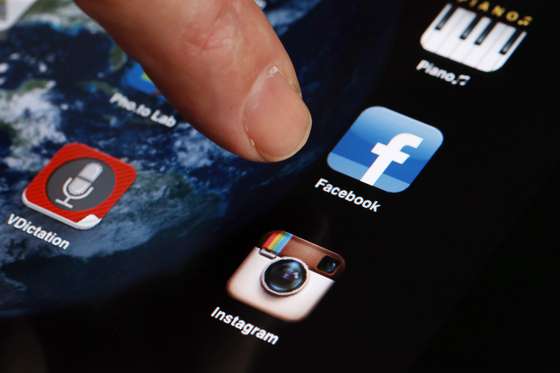 A man shows the smartphone photo sharing application Instagram on an Iphone on April 10, 2012 in Paris, one day after Facebook announced a billion-dollar-deal to buy the startup behind Instagram. The free mini-program lets people give classic looks to square photos using "filters" and then share them at Twitter, Facebook or other social networks. AFP PHOTO THOMAS COEX (Photo credit should read THOMAS COEX/AFP/Getty Images)