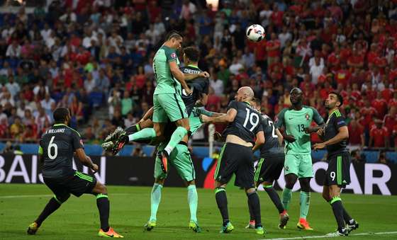 LYON, FRANCE - JULY 06: Cristiano Ronaldo of Portugal scores the opening goal during the UEFA EURO 2016 semi final match between Portugal and Wales at Stade des Lumieres on July 6, 2016 in Lyon, France. (Photo by Stu Forster/Getty Images)