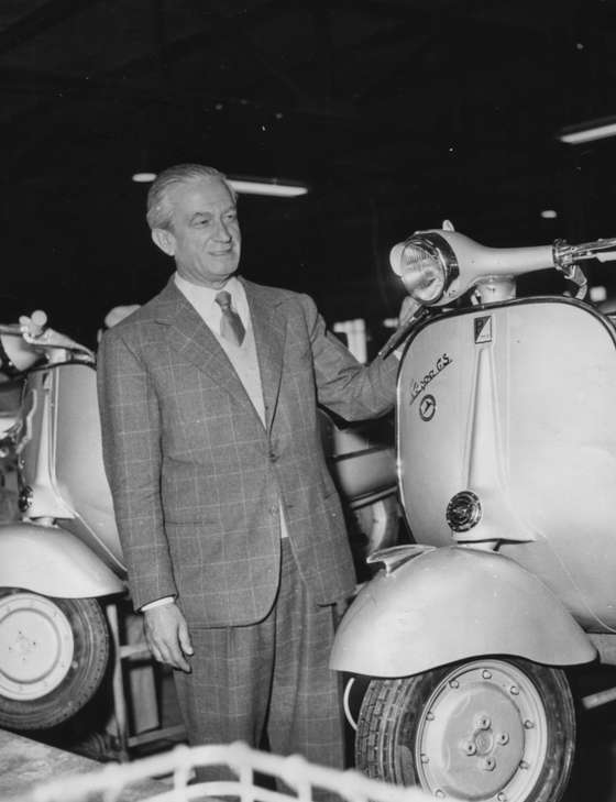 Italian industrialist Enrico Piaggio, manufacturer of Vespa scooters, pictured with one of the motor scooters at a Messerschmitt factory, Germany, October 2nd 1956. (Photo by Keystone Features/Hulton Archive/Getty Images)