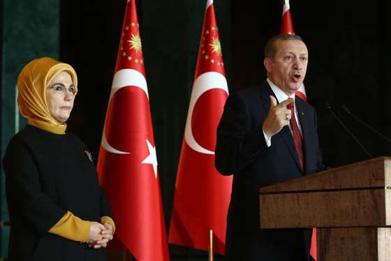 Turkish President Recep Tayyip Erdogan delivers a speech, flanked by his wife Emine, during a reception for World Smoking Cessation Day at the Presidential Palace in Ankara on February 9, 2016. / AFP / ADEM ALTAN (Photo credit should read ADEM ALTAN/AFP/Getty Images)