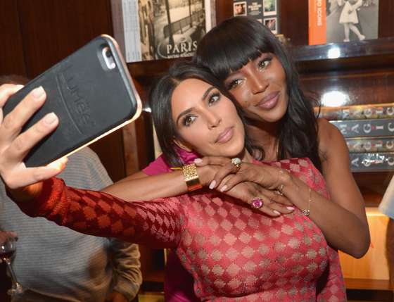BEVERLY HILLS, CA - APRIL 28: TV personality Kim Kardashian and model Naomi Campbell take a selfie during the Los Angeles launch of "Naomi" at Taschen Beverly Hills on April 28, 2016 in Beverly Hills, California. (Photo by Charley Gallay/Getty Images for Taschen)