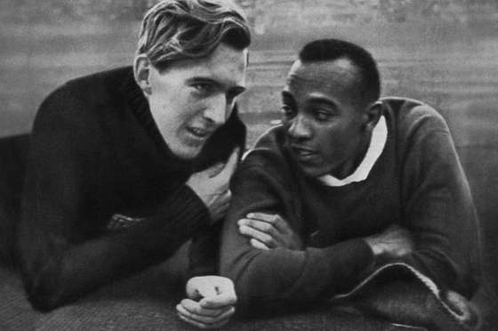 US champion Jesse Owens (R) and German champion Luz Long (L) chat together on the Berlin stadium 01 August 1936 during the Olympic Games where Owens captured 4 gold medals, 100m, 200m, 4x100m and long jump. Luz, second of Owens, captured the long jump silver. Grandson of a slave and legendary athlete, "Jesse" Owens established 6 world records in 1935. "Jesse" Owens retained his 100m world record for 20 years and his long jump world record for 25 years (until 1960). (Photo credit should read CORR/AFP/Getty Images)