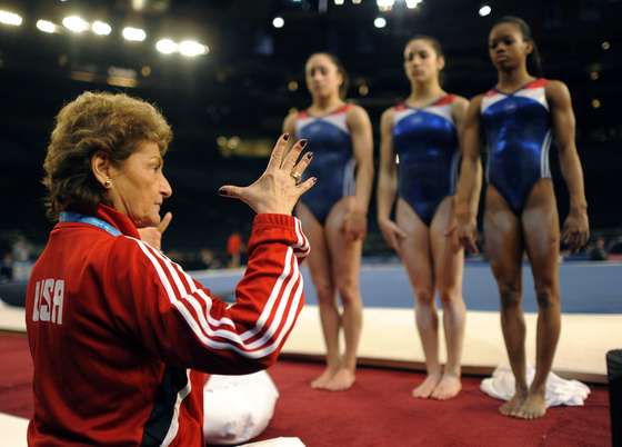 US National Team coach Marta Karolyi with Jordyn Wieber,Alexnadra Raisman and Gabby Douglas of the USA during practice at the 2012 AT&T American Cup at Madison Square Garden in New York City March 2, 2012. The event , which takes place March 3, will feature all-around competition for both men and women, is part of the FIG's World Series Cup series and is one of four all-around World Cup events in 2012.AFP PHOTO/ TIMOTHY A. CLARY (Photo credit should read TIMOTHY A. CLARY/AFP/Getty Images)