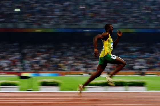 BEIJING - AUGUST 20: Usain Bolt of Jamaica competes on his way to breaking the world record with a time of 19.30 to win the gold medal in the Men's 200m Final at the National Stadium during Day 12 of the Beijing 2008 Olympic Games on August 20, 2008 in Beijing, China. (Photo by Julian Finney/Getty Images)