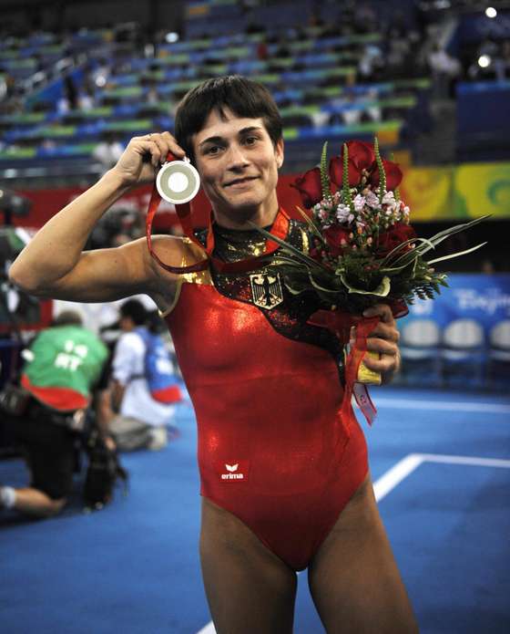 Germany's Oksana Aleksandrovna Chusovitina displays her silver medal during he medal ceremony of the women's vault final of the artistic gymnastics event of the Beijing 2008 Olympic Games in Beijing on August 17, 2008. North Korea's Un Jong Hong won the gold, Germany's Oksana Aleksandrovna Chusovitina the silver and China's Fei Cheng the bronze. AFP PHOTO / LLUIS GENE (Photo credit should read LLUIS GENE/AFP/Getty Images)