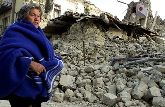 SAN GIULIANO DI PUGLIA, ITALY - NOVEMBER 1: A person walks by a home brought down by an earthquake November 1, 2002 in San Giuliano di Puglia, in south central Italy. A series of aftershocks continue to jolt the south-central Molise region as emergency crews search the debris. An earthquake measuring 5.4 hit San Giuliano di Puglia October 31, 2002 causing a school to collapse, leaving 26 children dead. (Photo by Salvadore Laporta/Getty Images)