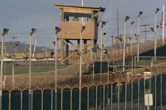 In this photo reviewed by US military officials, a US military member mans one of the watch towers at Camp Delta at the US Detention Center in Guantanamo Bay, Cuba on March 30, 2010. AFP Photo/Paul J. Richards (Photo credit should read PAUL J. RICHARDS/AFP/Getty Images)