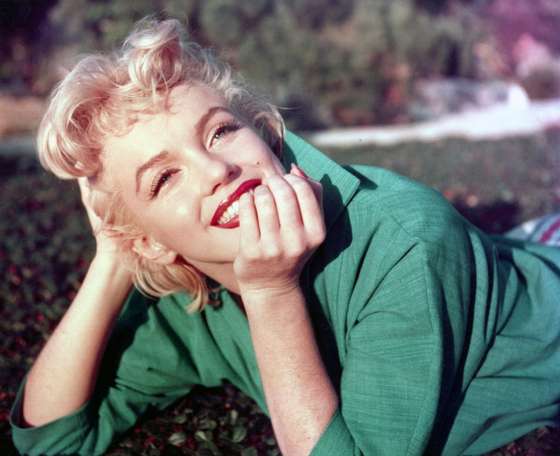 PALM SPRINGS, CA - 1954: Actress Marilyn Monroe poses for a portrait laying on the grass in 1954 in Palm Springs, California. (Photo by Baron/Getty Images)