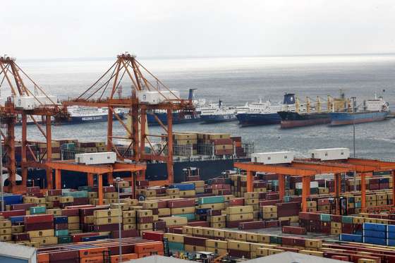 PIREAUS, GREECE - FEBRUARY 11: Shipping container cranes line the Pireaus cargo port on February 11, 2015 in Pireaus, Greece. The assent of the new radical Syriza government brought it's legislative agenda which put a stop to any further growth to the partly Chinese-run shipyard. Chinese shipping giant Cosco controls two of the three container terminals. (Photo by Milos Bicanski/Getty Images)