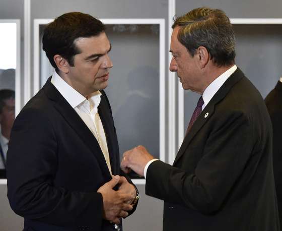 Greek Prime Minister Alexis Tsipras (L) listens to European Central Bank chief Mario Draghi during an Eurozone Summit meeting at the EU headquarters in Brussels on July 7, 2015. AFP PHOTO / JOHN THYS (Photo credit should read JOHN THYS/AFP/Getty Images)